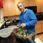 Paul Chatlin preparing food in his kitchen. (Photo Donna Agusti C&G News)